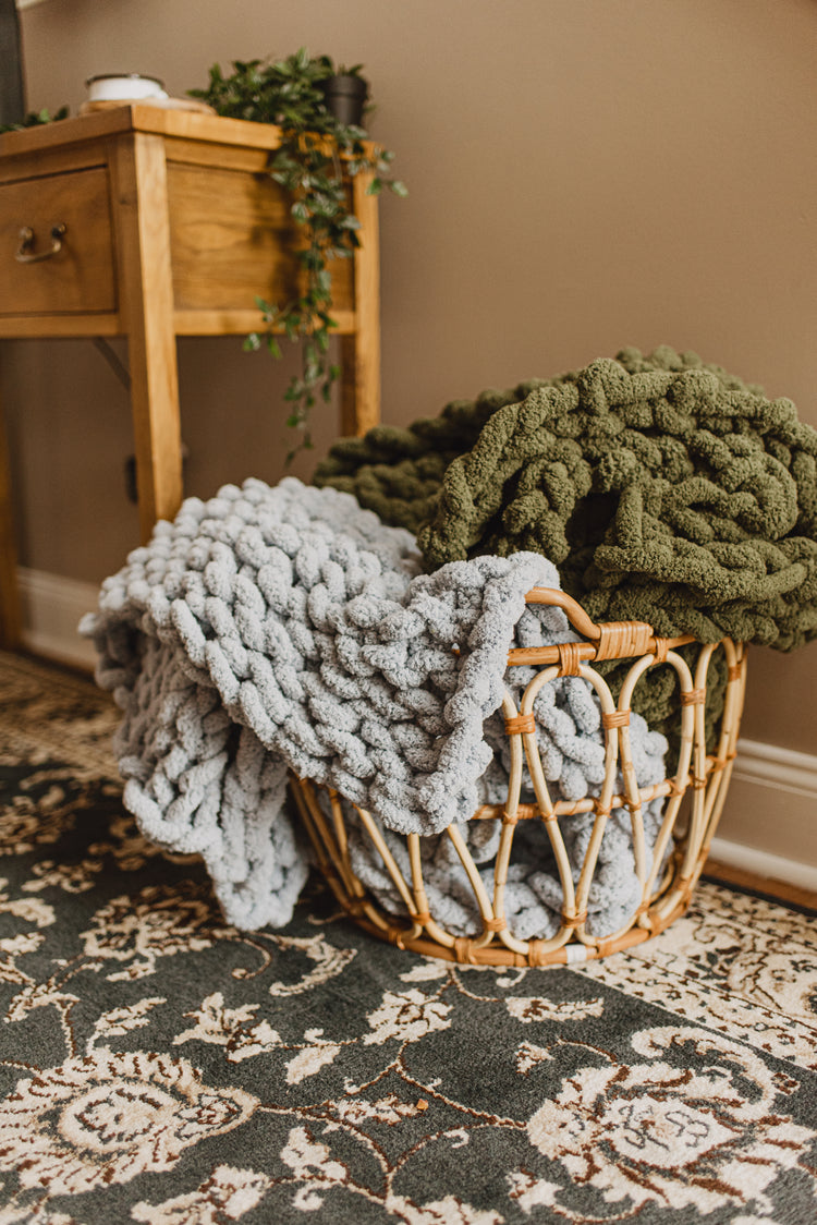 Knitted blankets in a basket