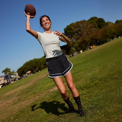 Socks that Support Youth Sports | Black Footballs